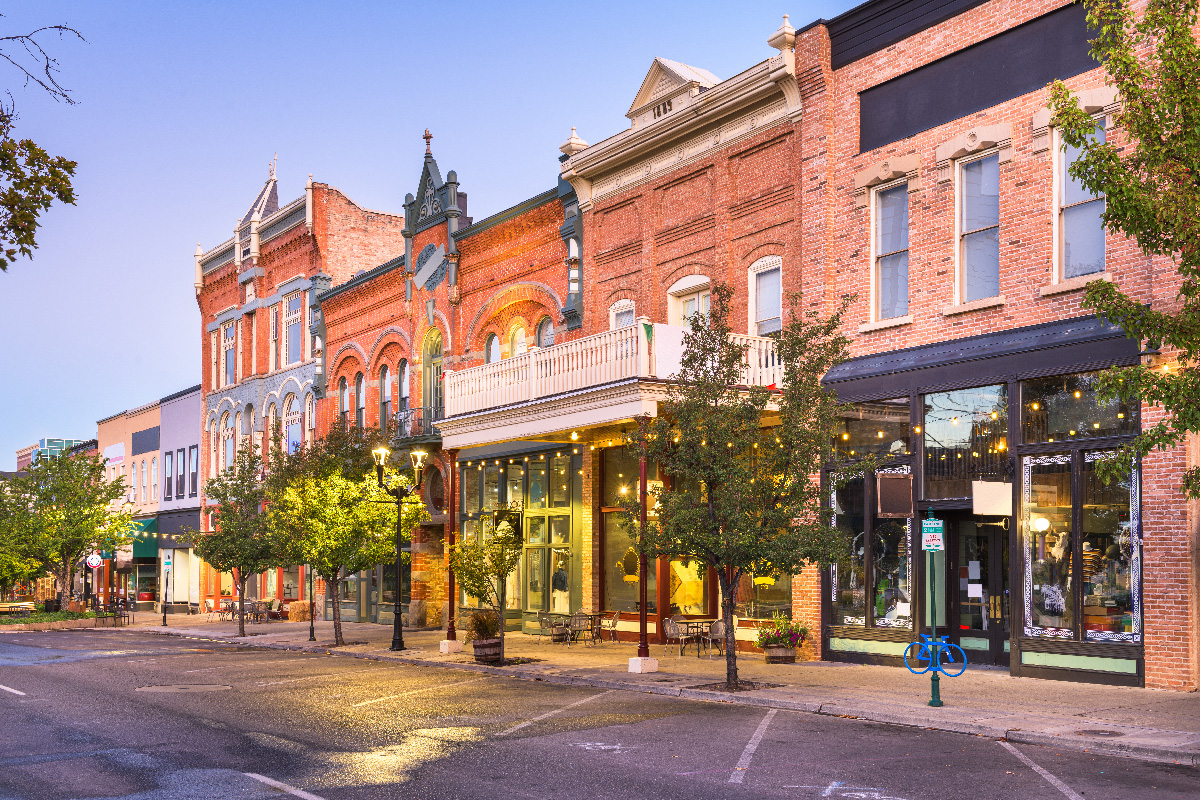 A historic small-town main street of independent shops at dusk
